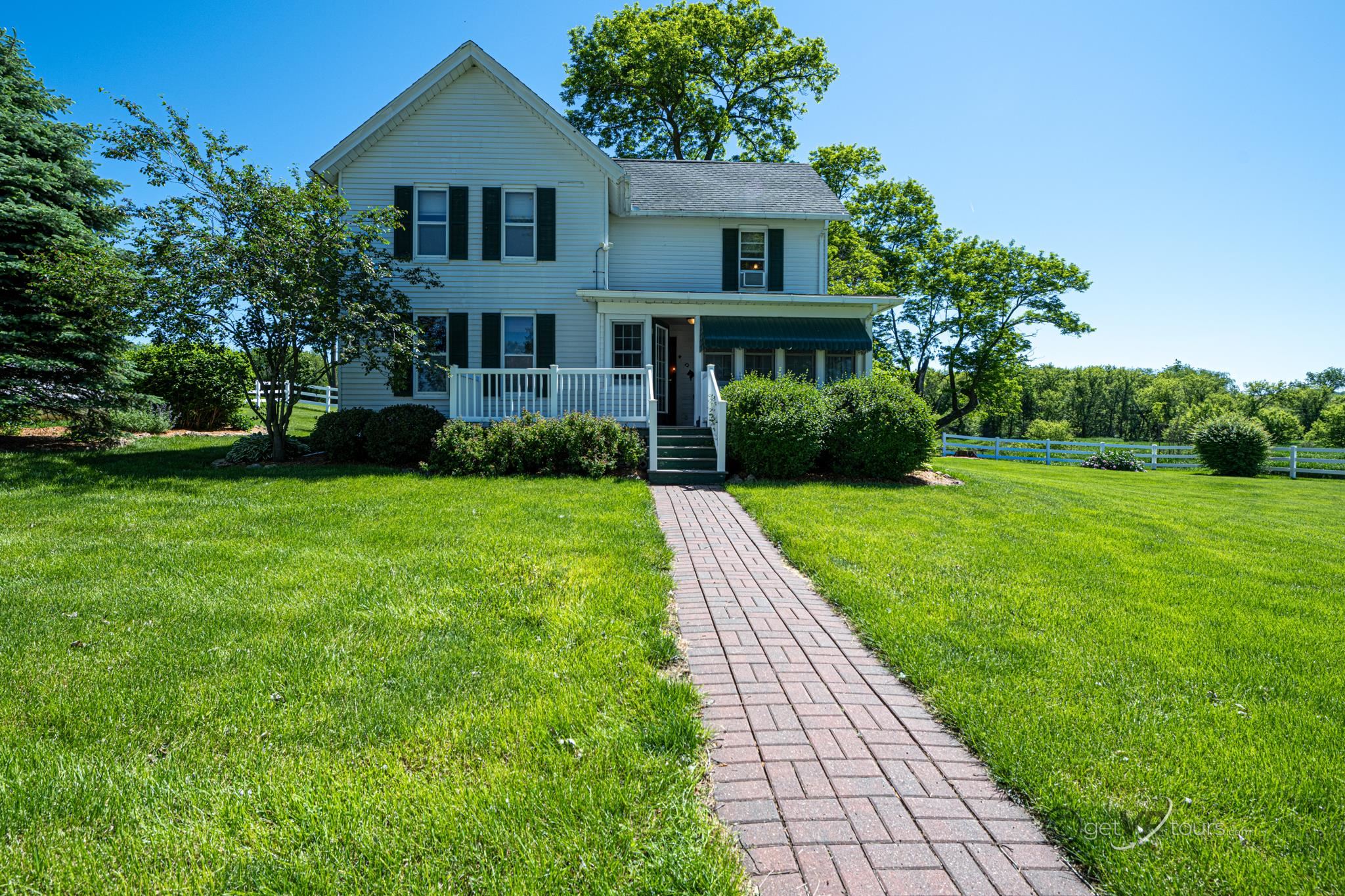 a front view of house with yard and green space