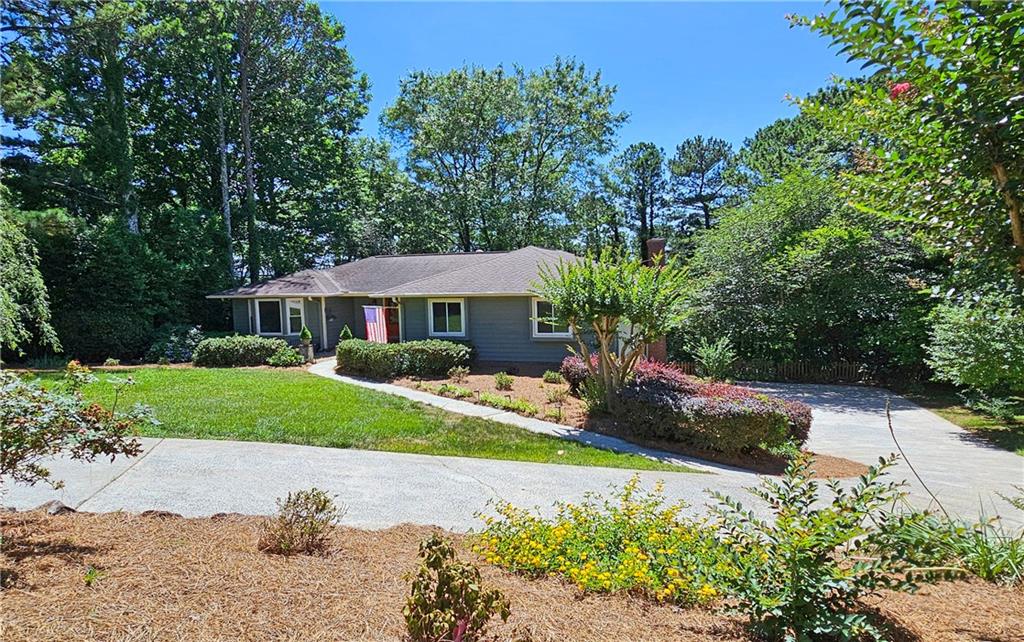 a front view of a house with a yard and porch