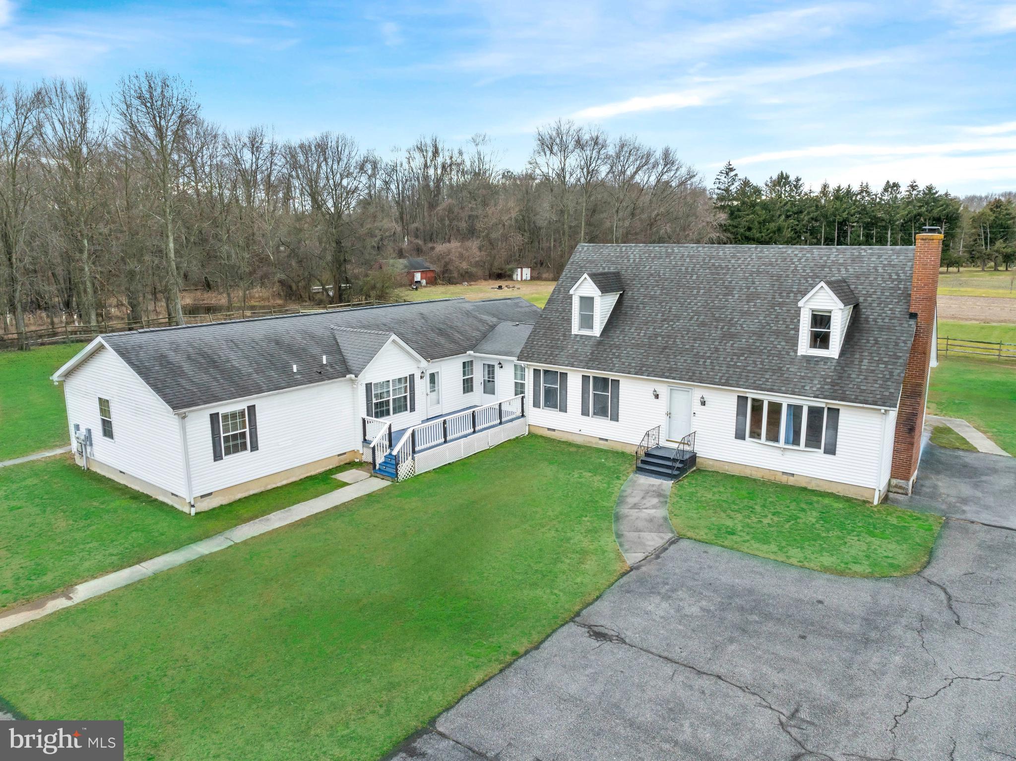 a aerial view of a house with a yard table and chairs