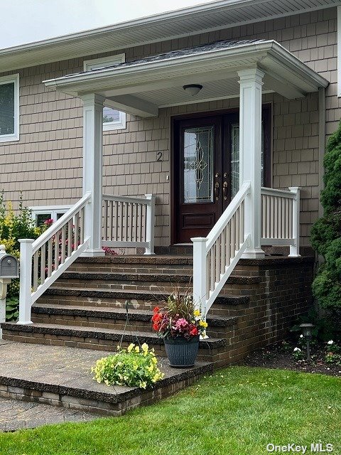 a view of a house with wooden deck and a porch