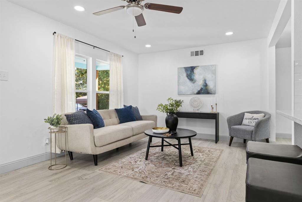 a living room with furniture and a potted plant