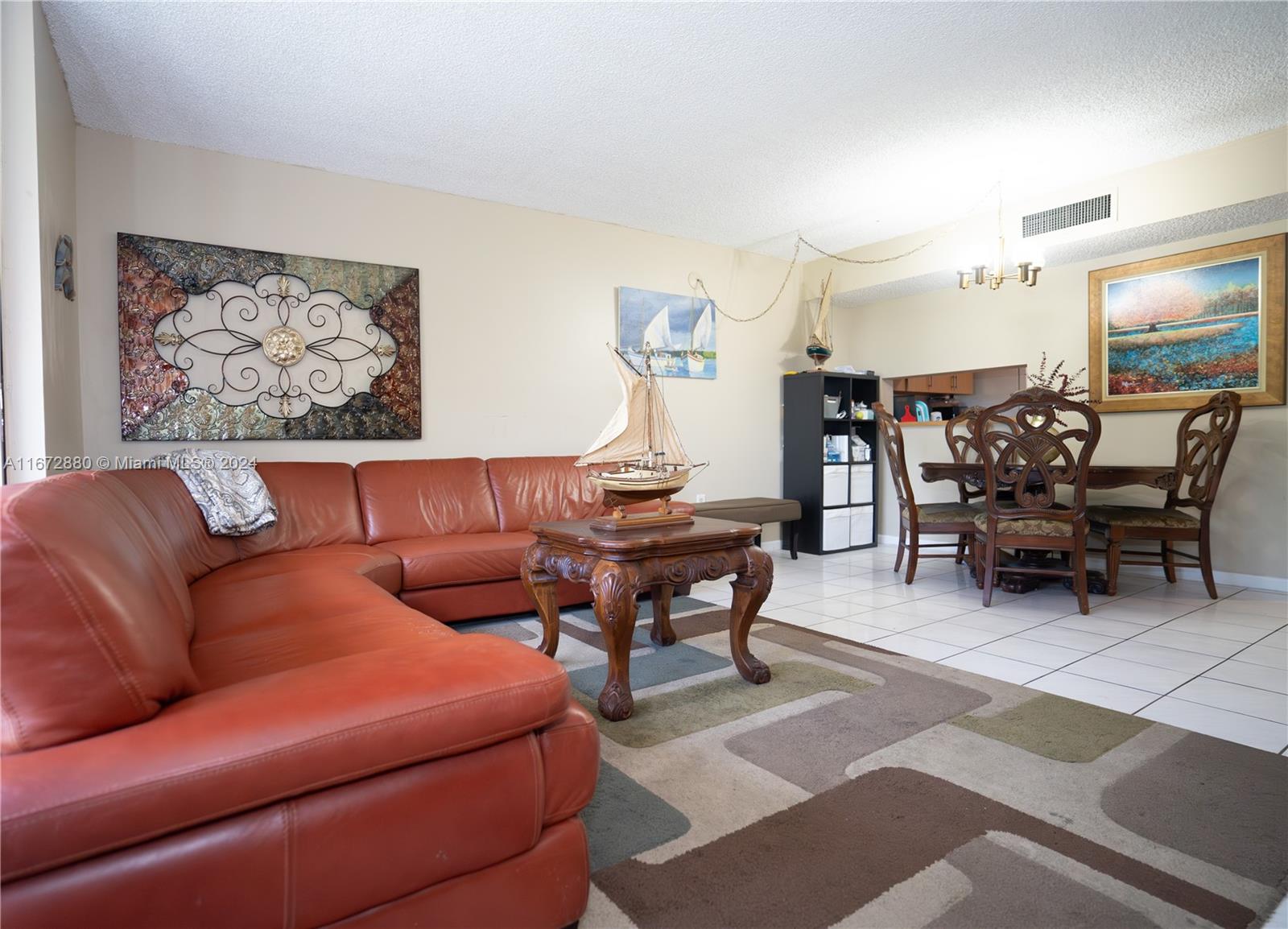 a living room with furniture a table and chairs