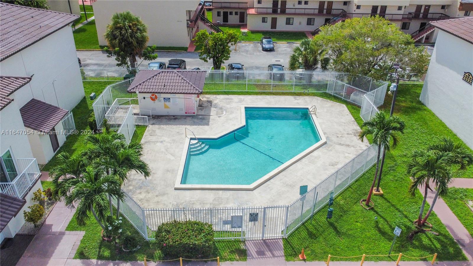 an aerial view of a house with a garden and swimming pool