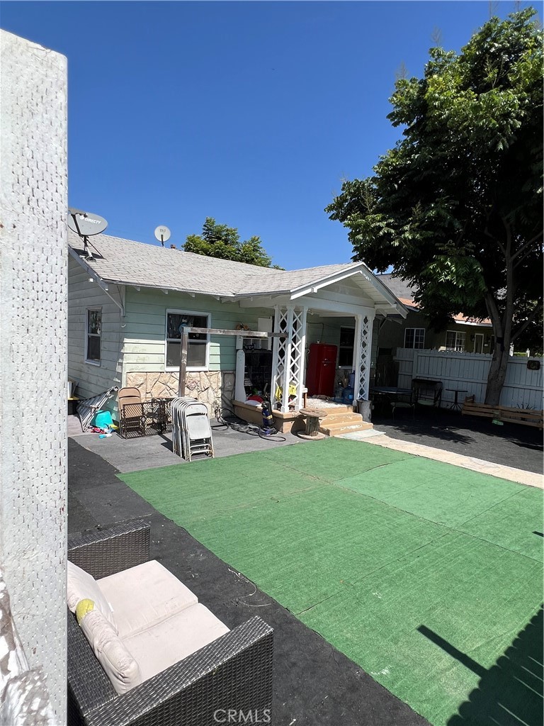 a view of a house with backyard porch and sitting area