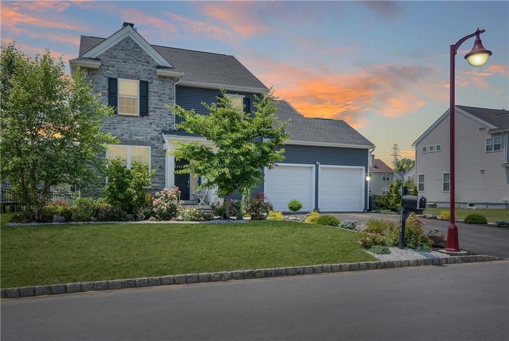 a front view of a house with a yard and garage