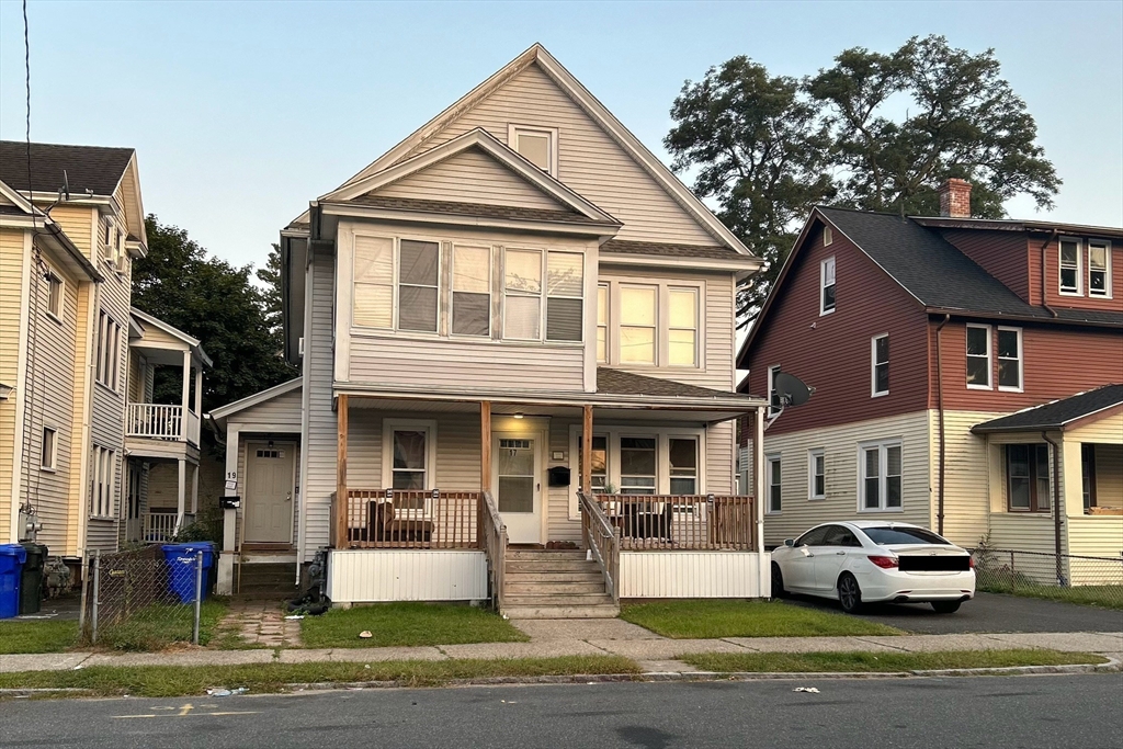 a front view of a residential apartment building with a yard