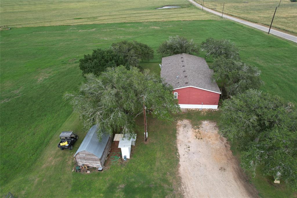 an aerial view of a house with a yard