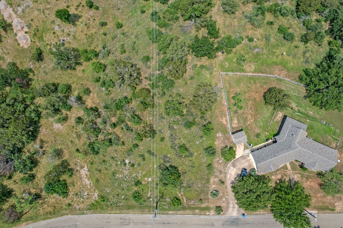 an aerial view of a residential houses with yard