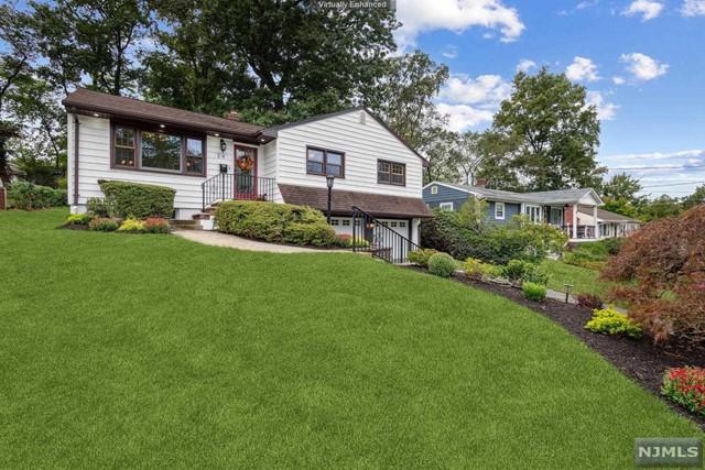 a front view of a house with a yard and porch