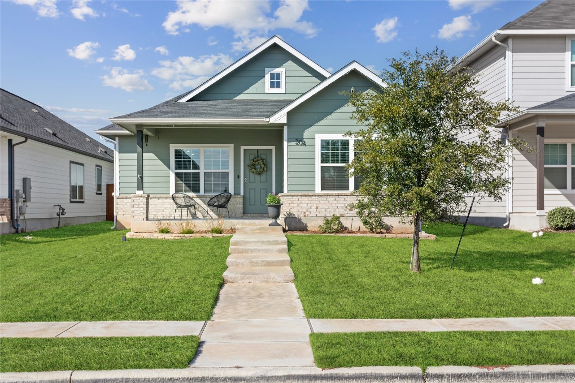 a front view of a house with a yard table and chairs