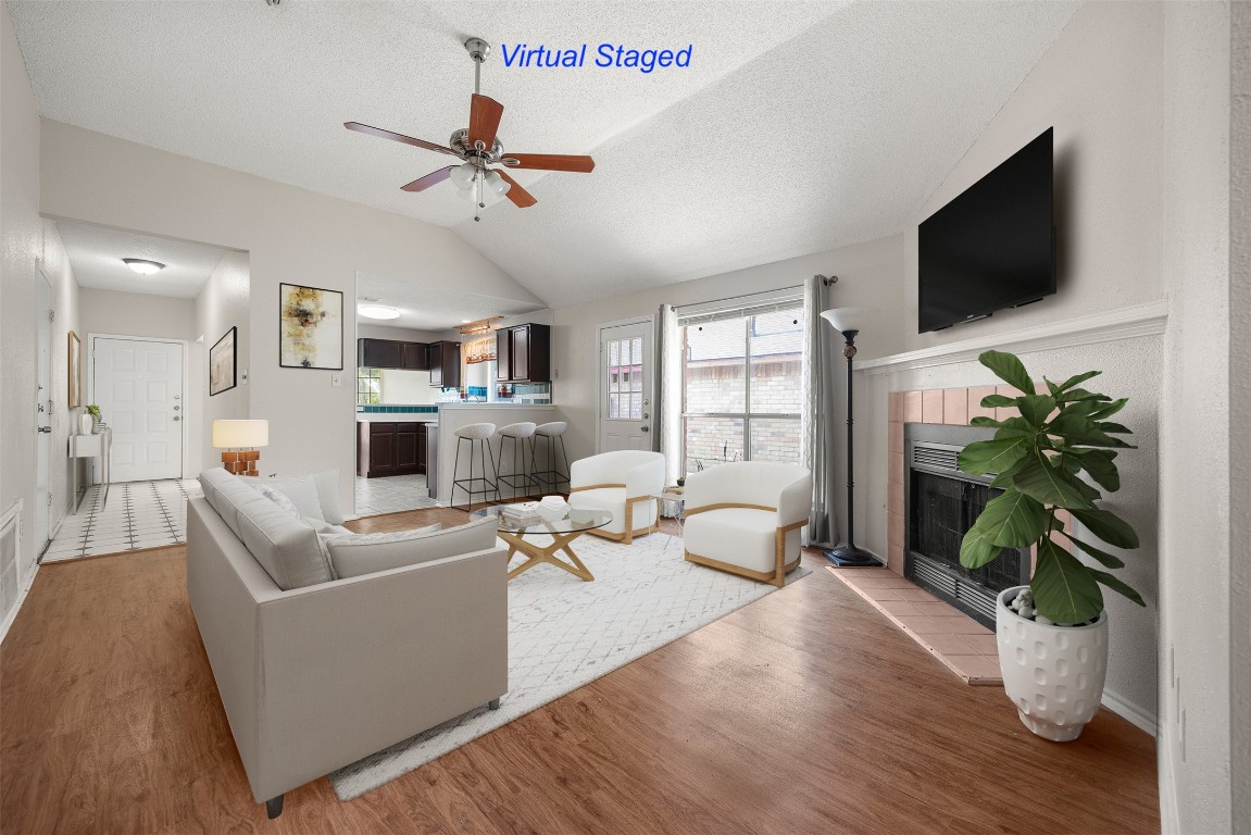 a living room with furniture a flat screen tv and a potted plant