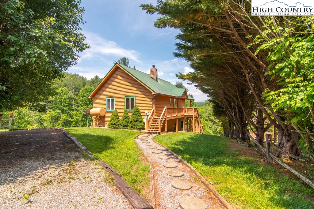 a view of house with yard