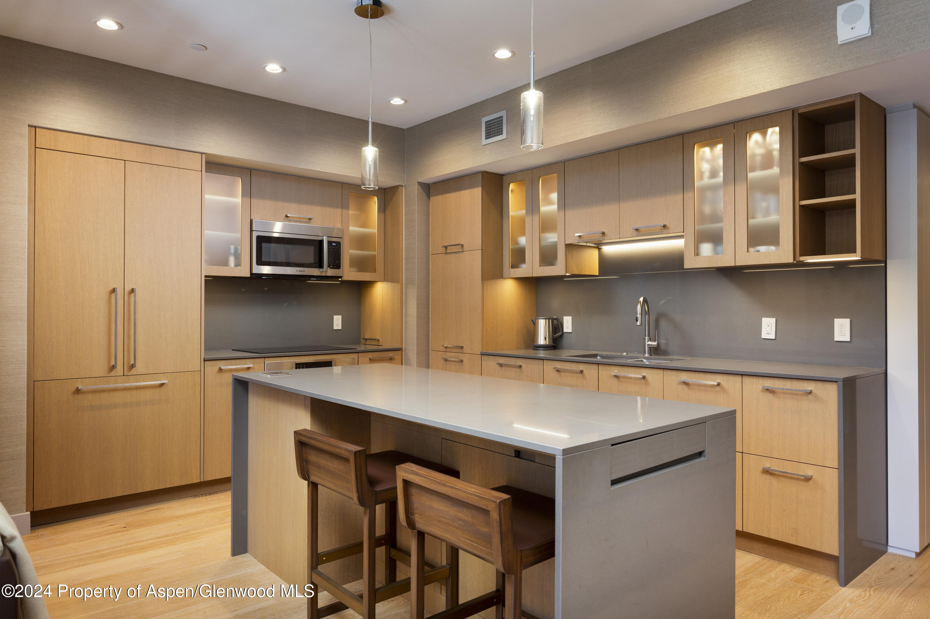 a kitchen with kitchen island a stove a sink and a refrigerator