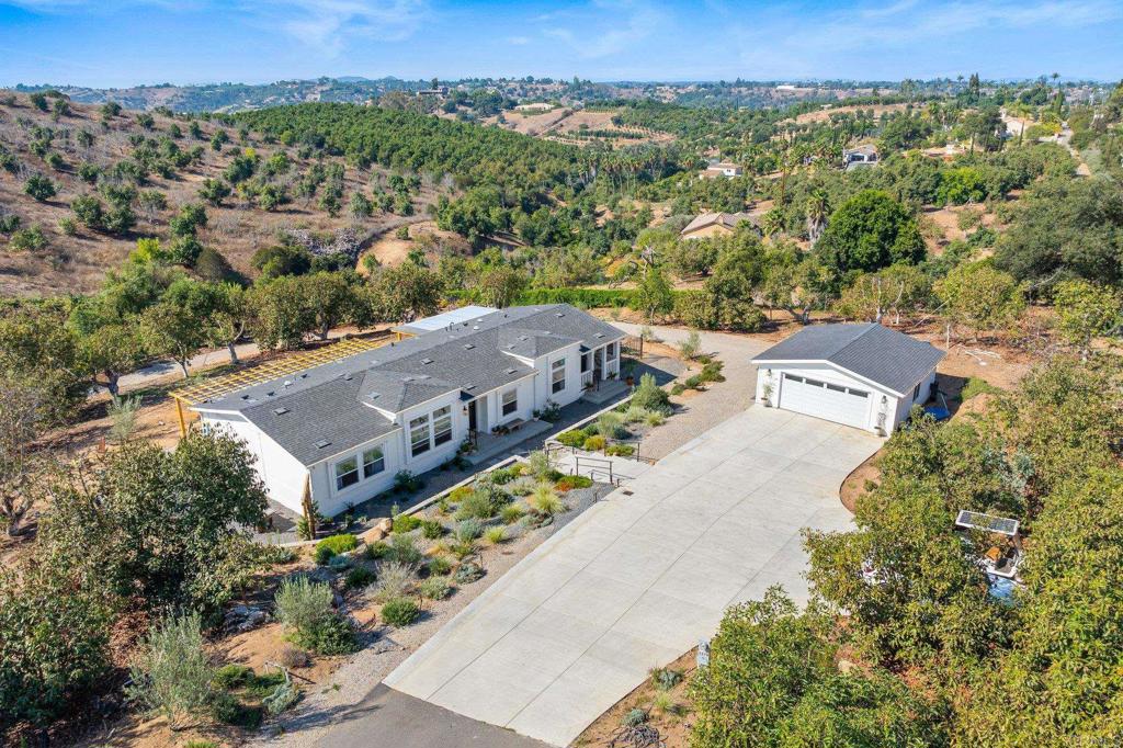 an aerial view of multiple houses with a yard