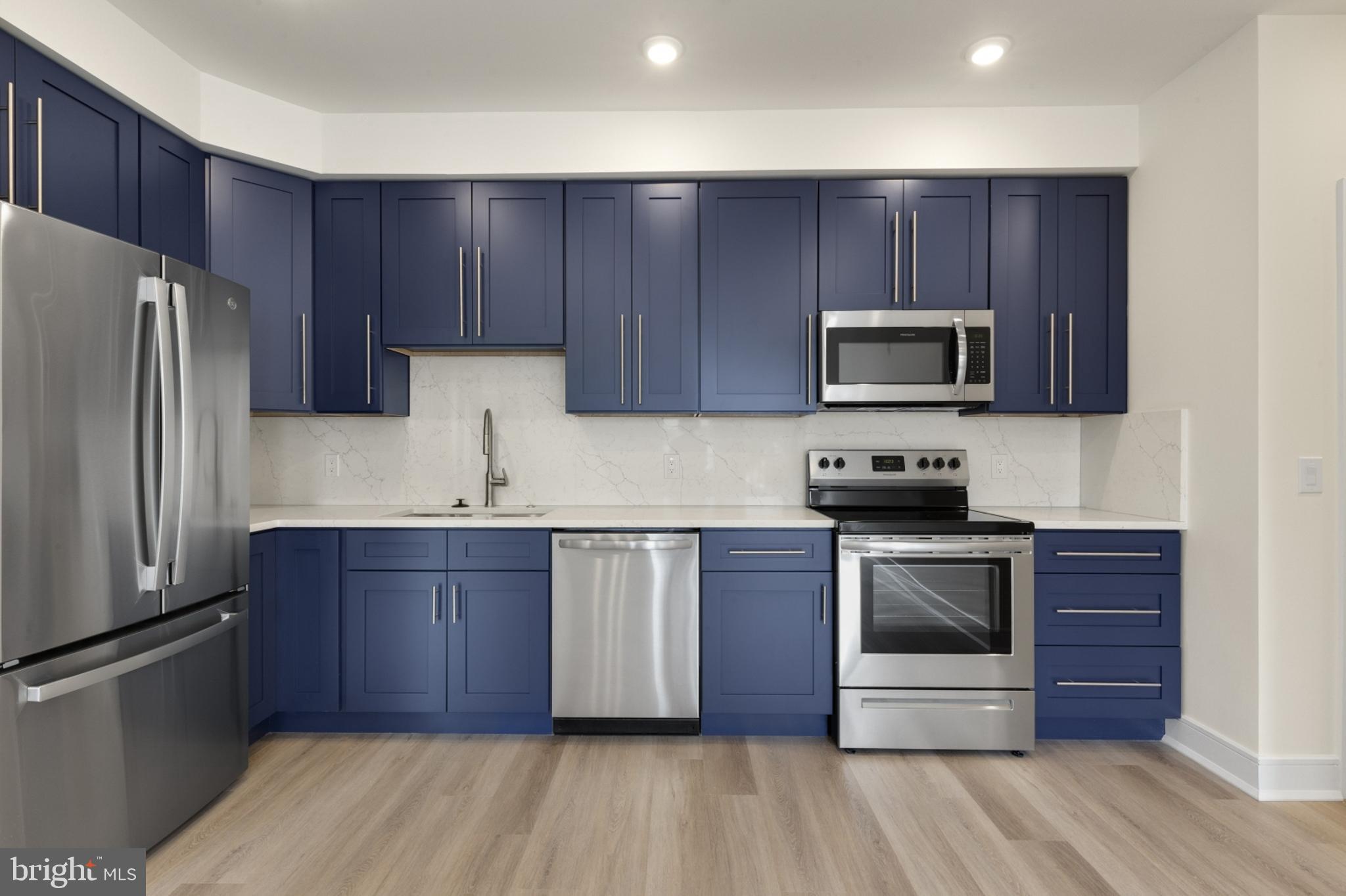 a kitchen with wooden cabinets and stainless steel appliances