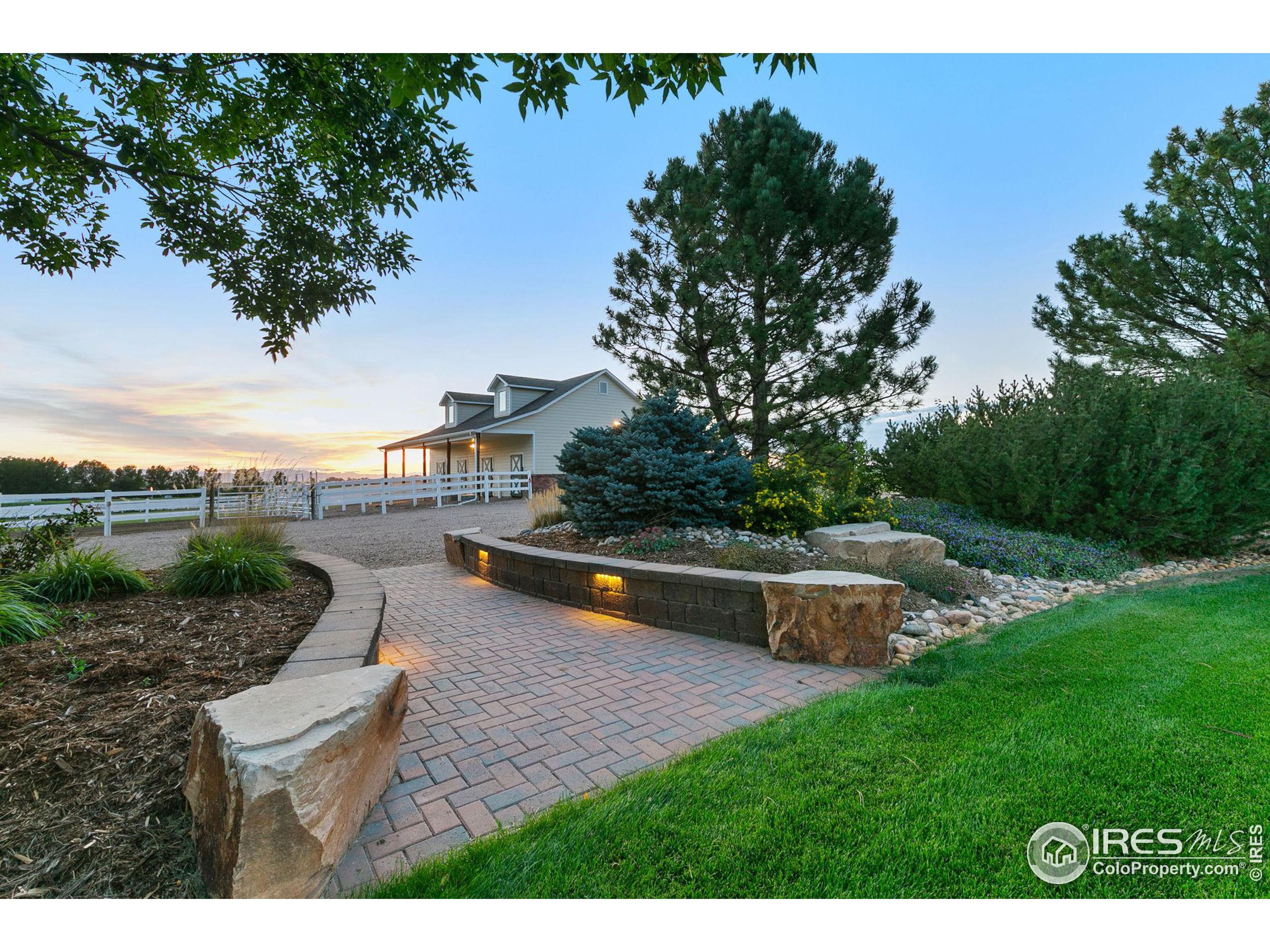 a swimming pool with outdoor seating and garden