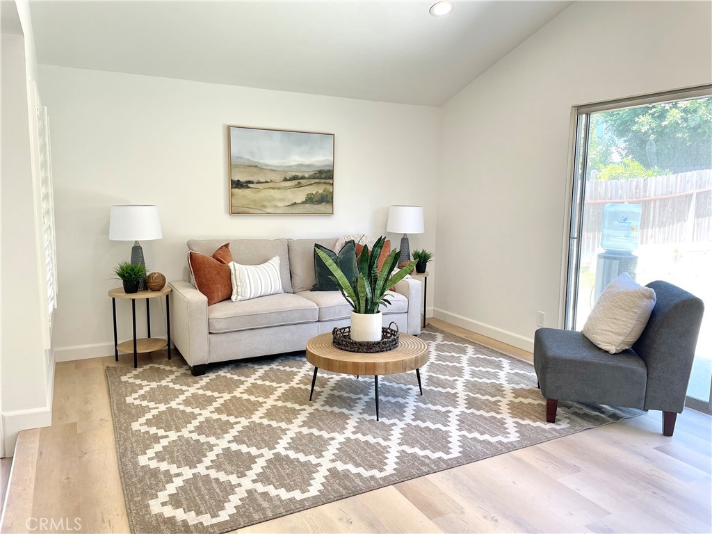 a living room with furniture and a potted plant