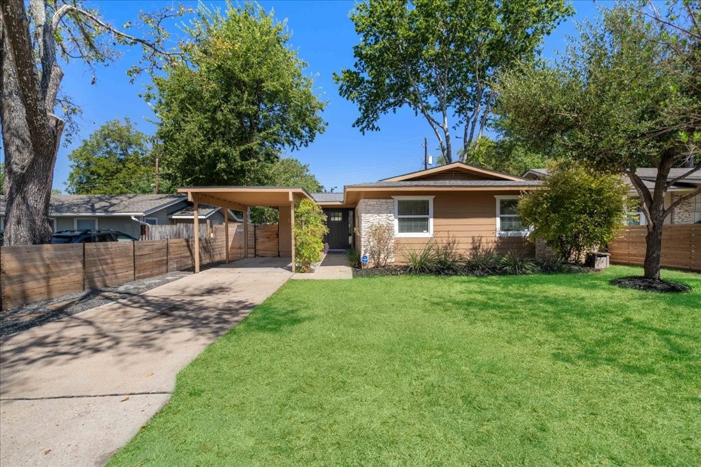 Great curb appeal with a long driveway and covered parking