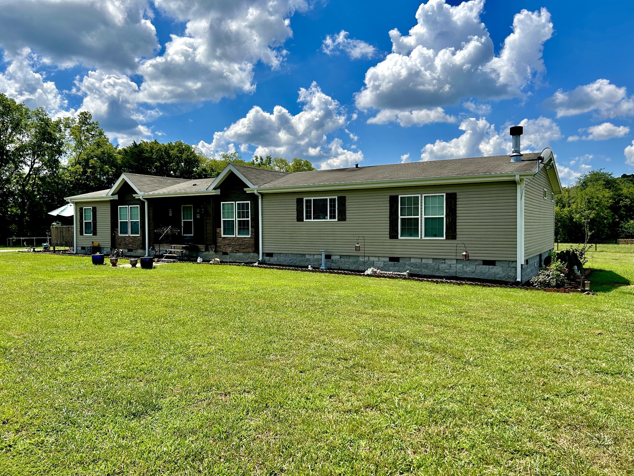 a front view of house with yard and green space