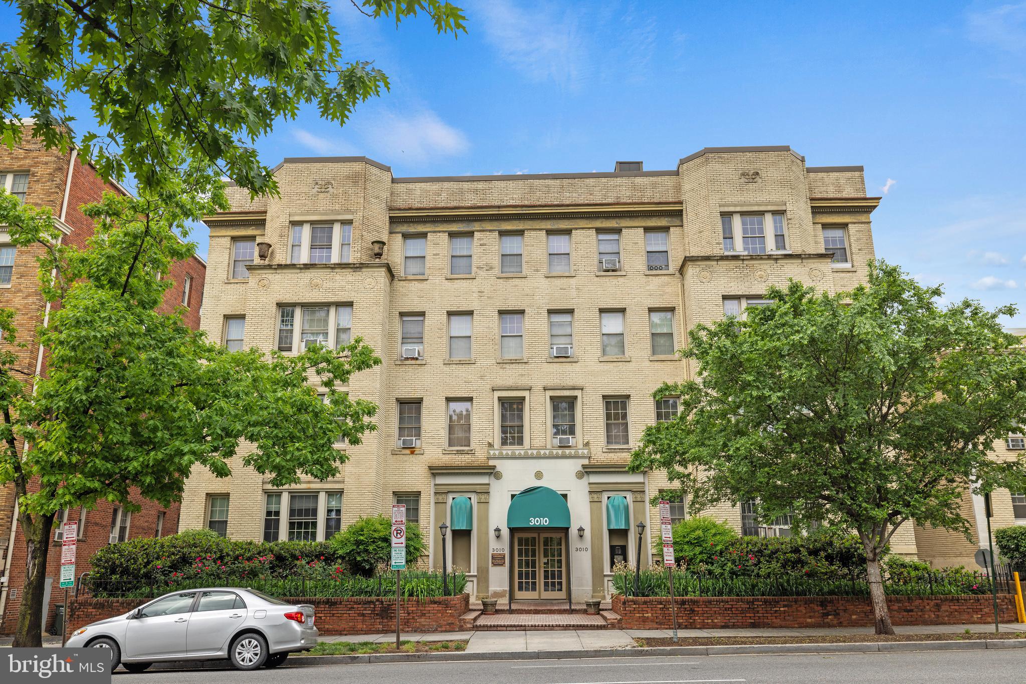 a front view of a residential apartment building with a yard