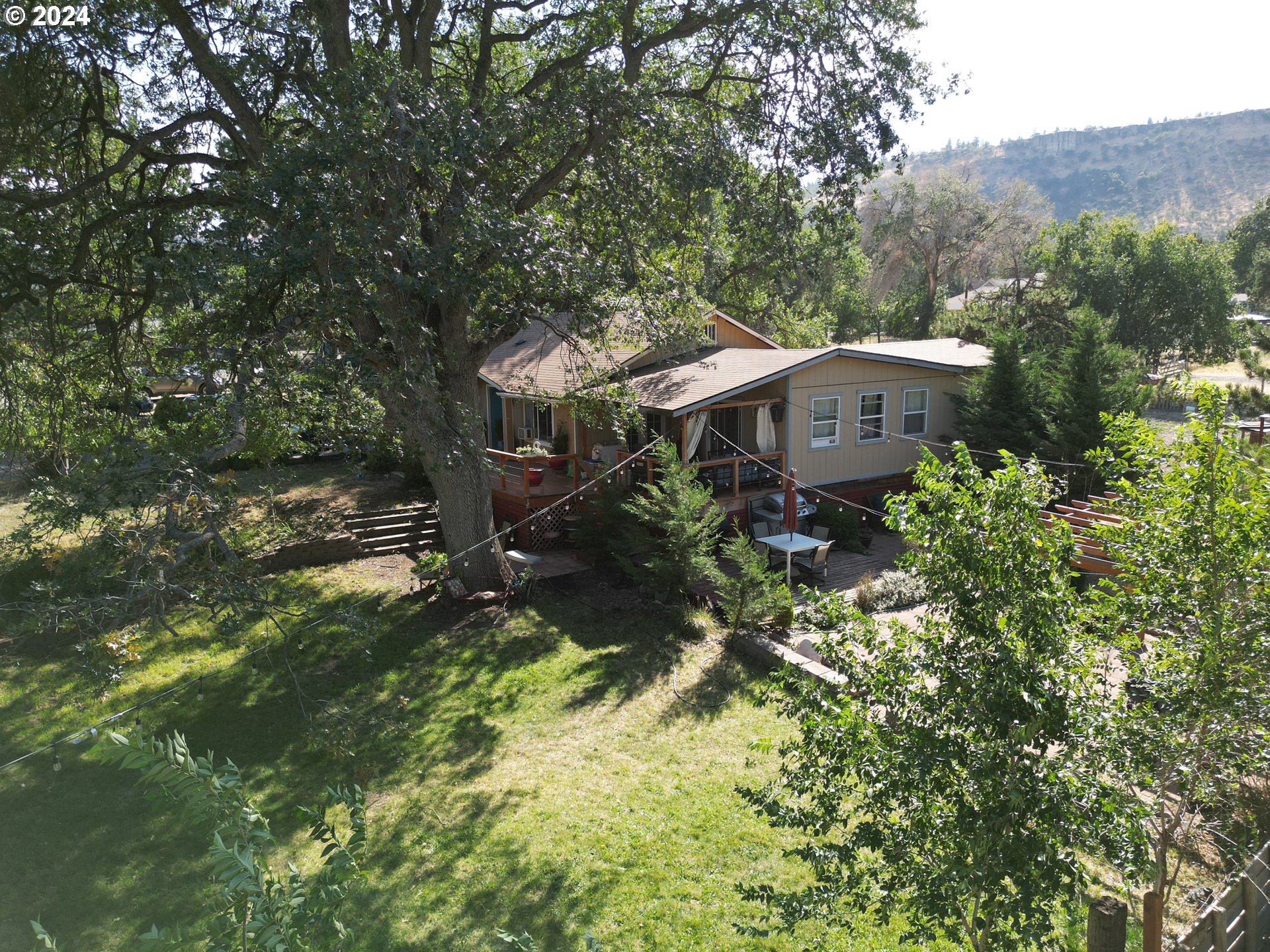 an aerial view of a house with yard and outdoor seating