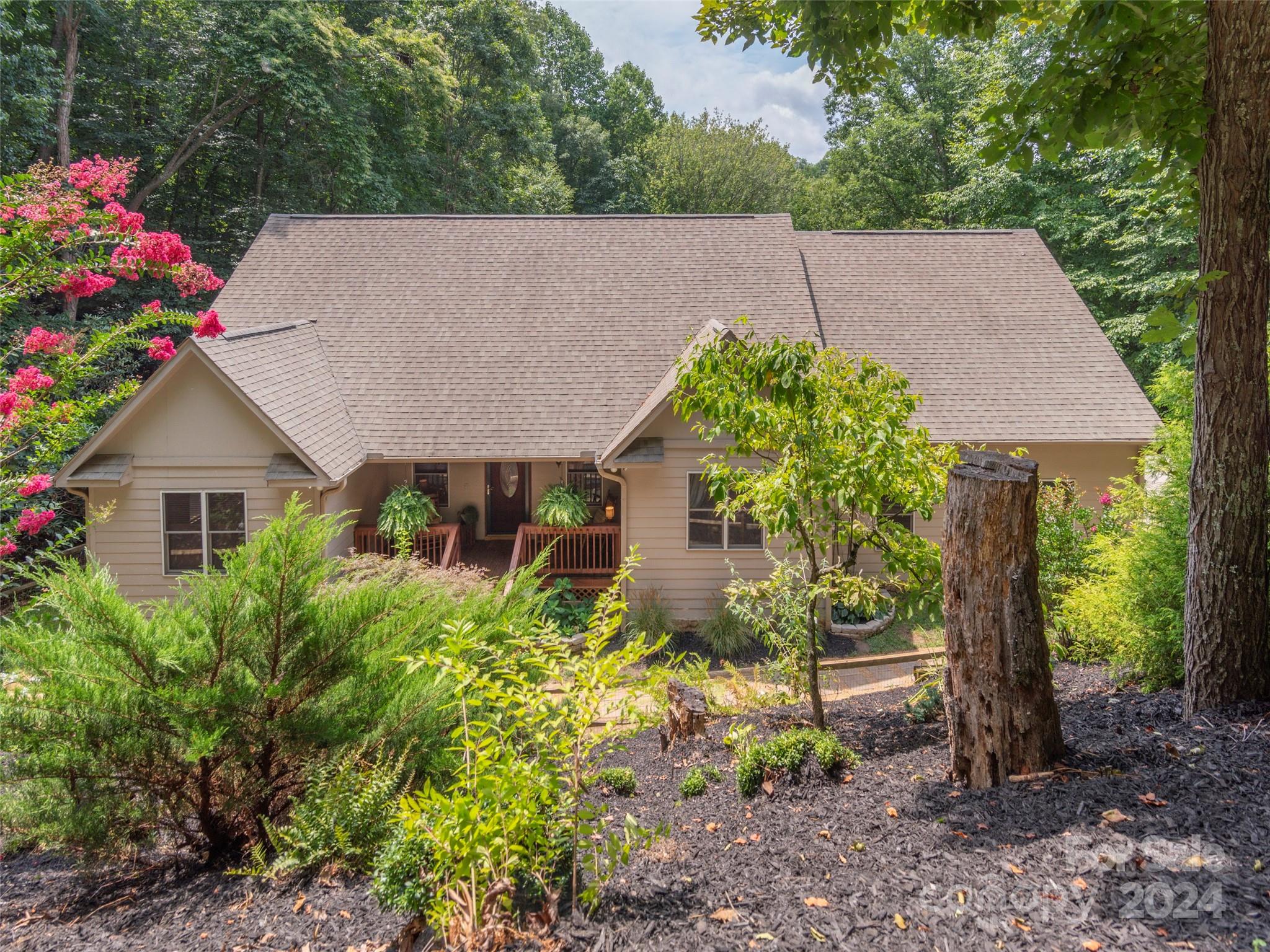 a aerial view of a house with a yard and potted plants