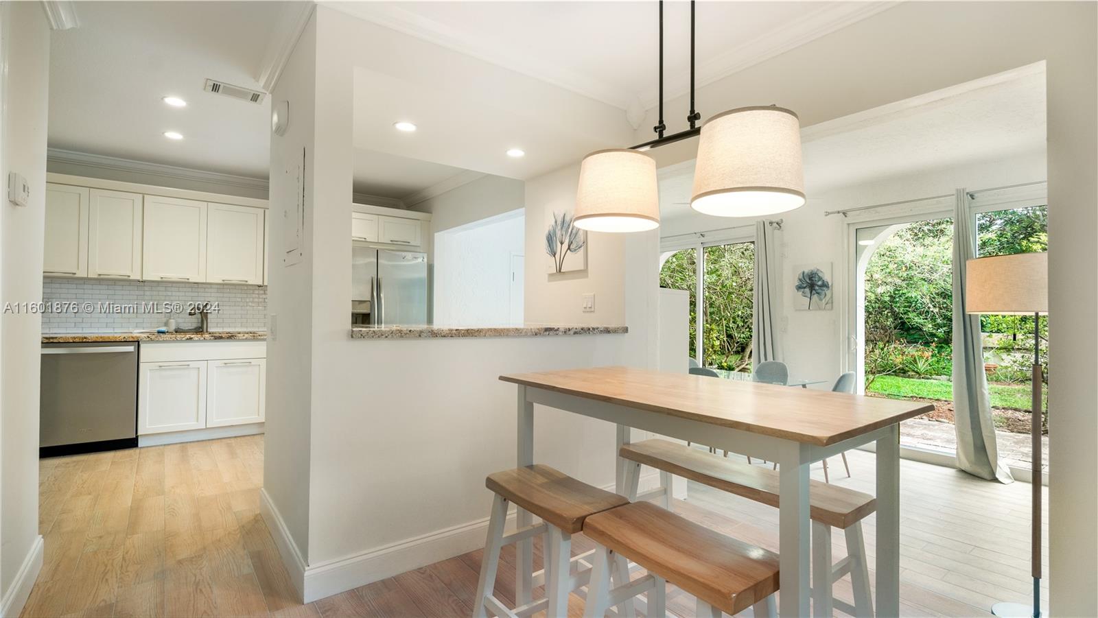 a kitchen with a table chairs sink and cabinets