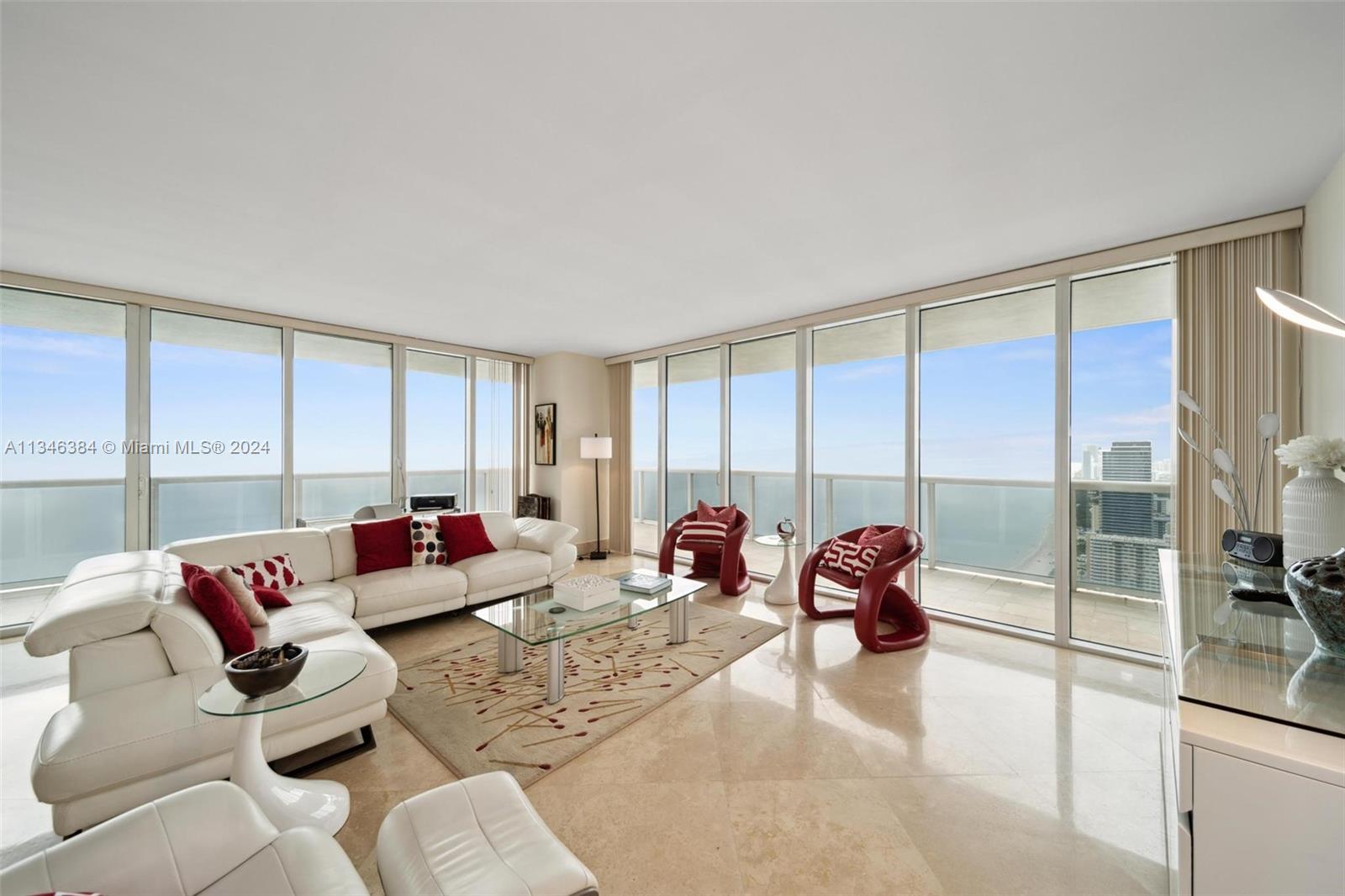 a living room with furniture and large windows