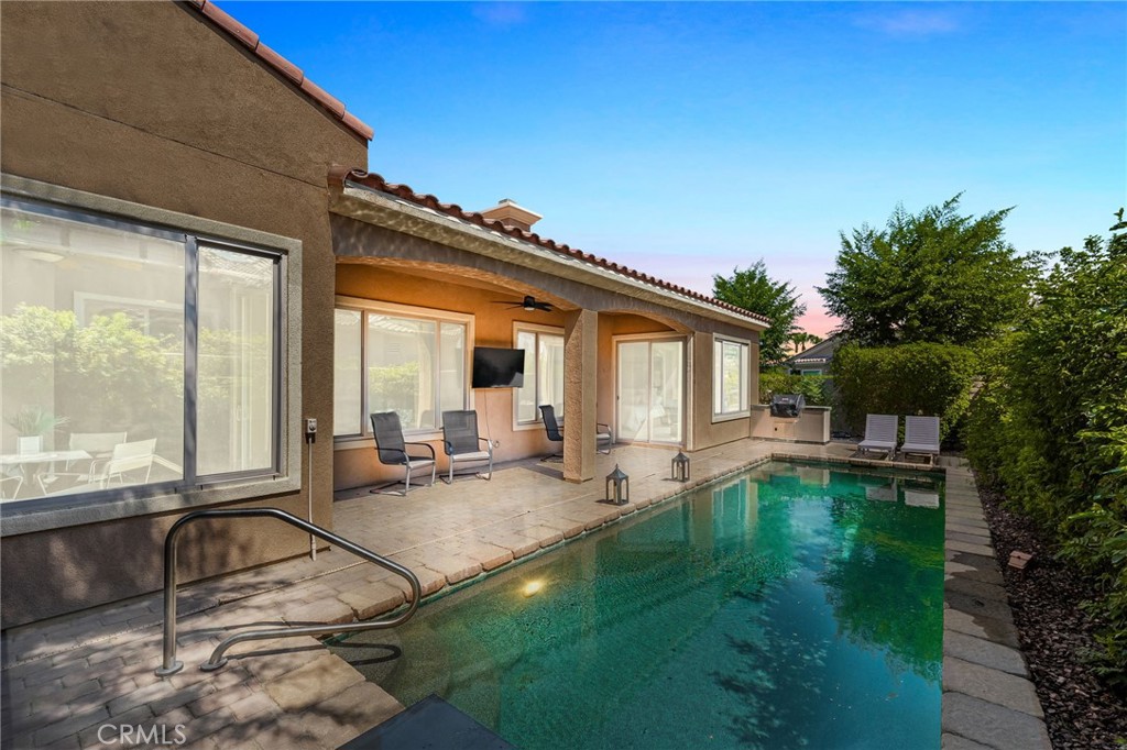 a view of a house with backyard sitting area and garden