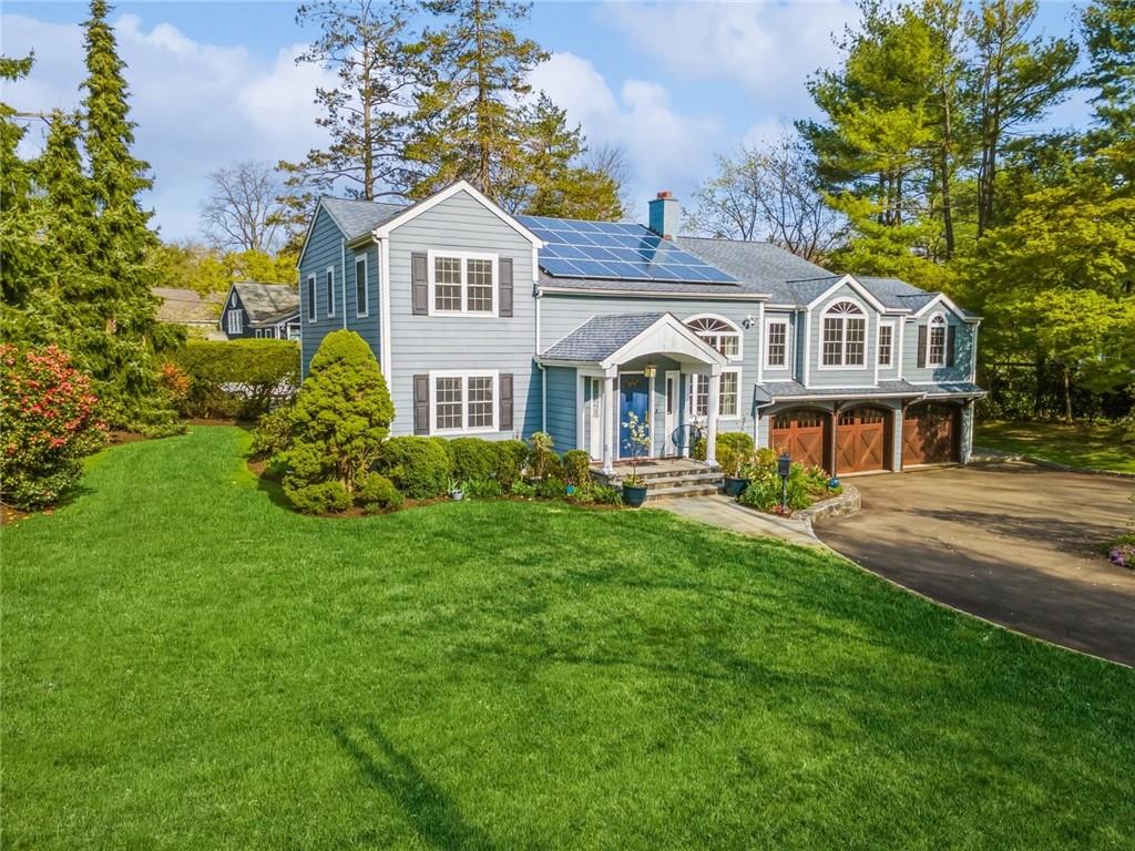 a front view of a house with a garden