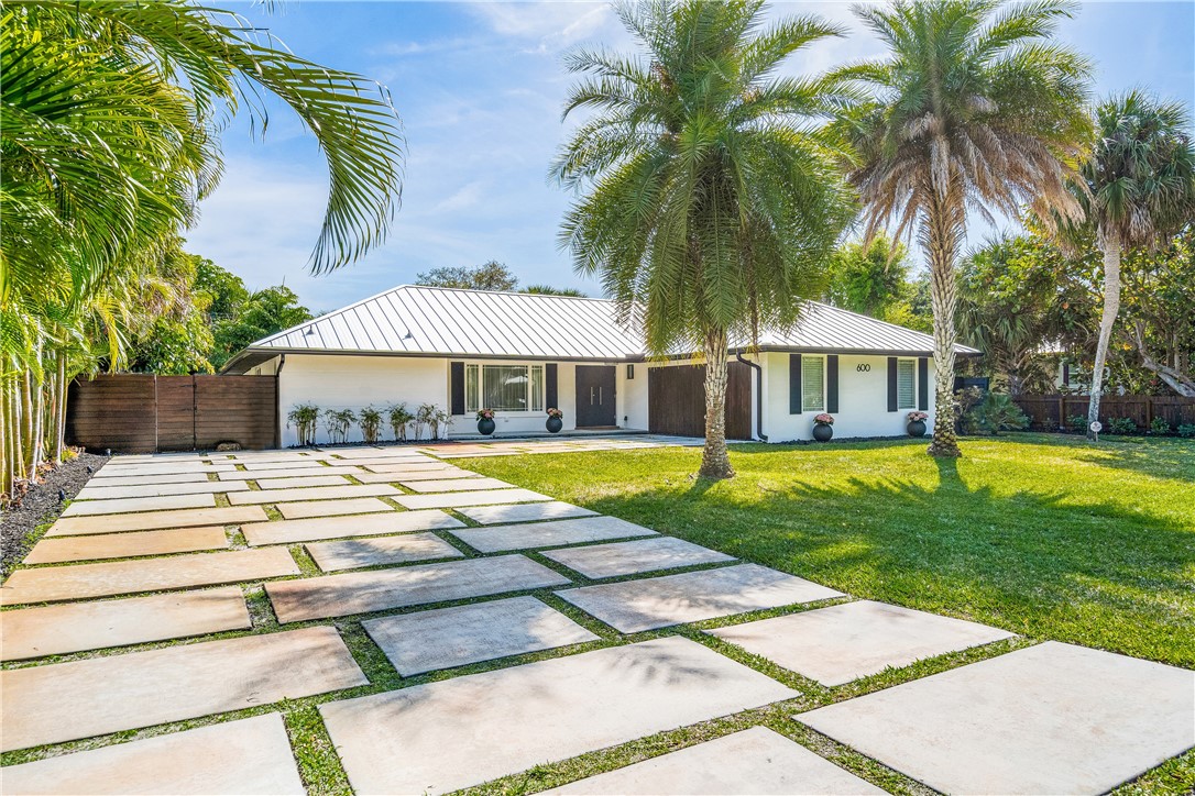 a view of a house with swimming pool and sitting area