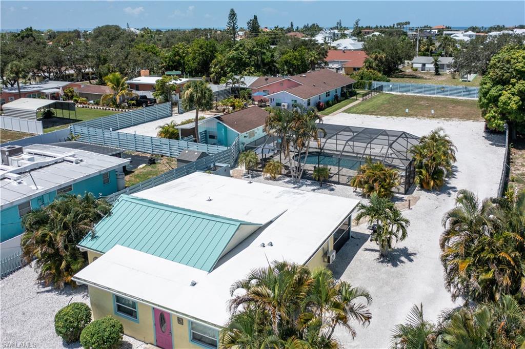 an aerial view of residential houses with outdoor space and parking