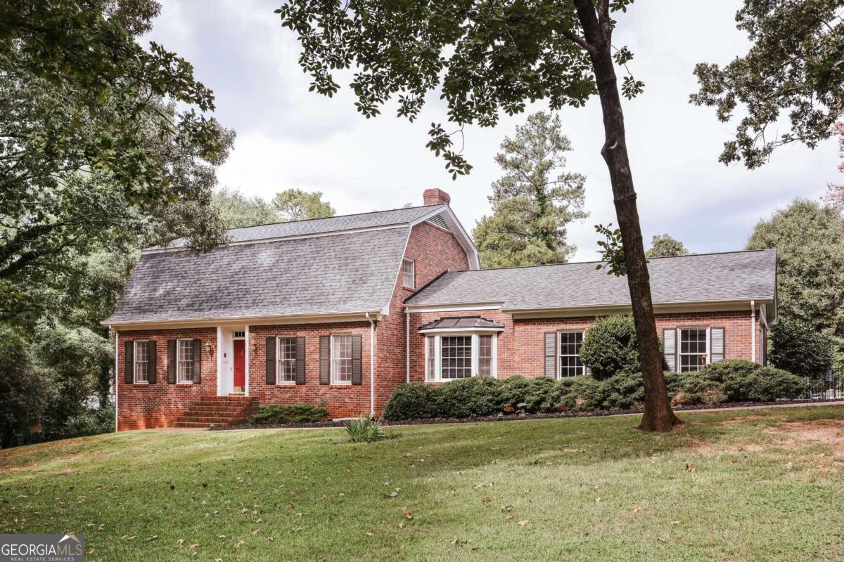 a front view of a house with a garden