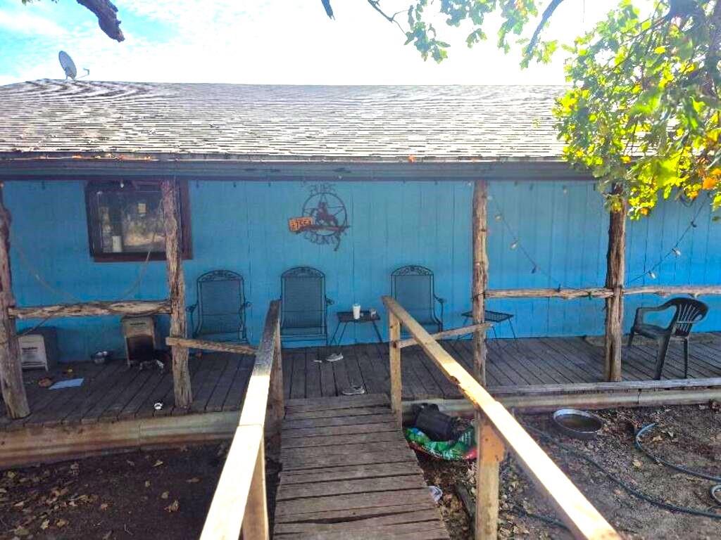 a roof deck with table and chairs