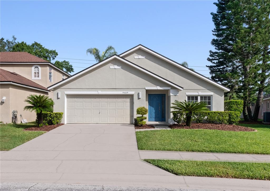 a front view of a house with a yard and garage