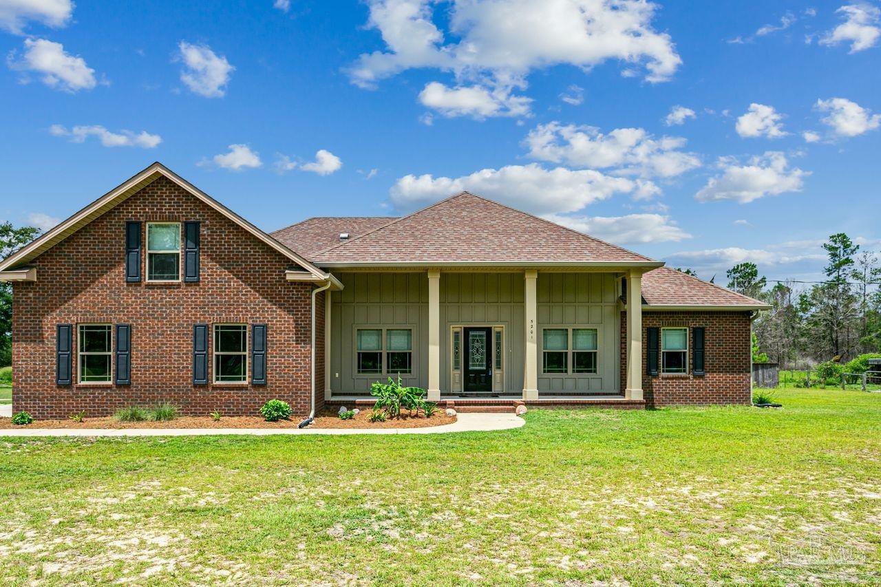 a front view of a house with a garden and porch