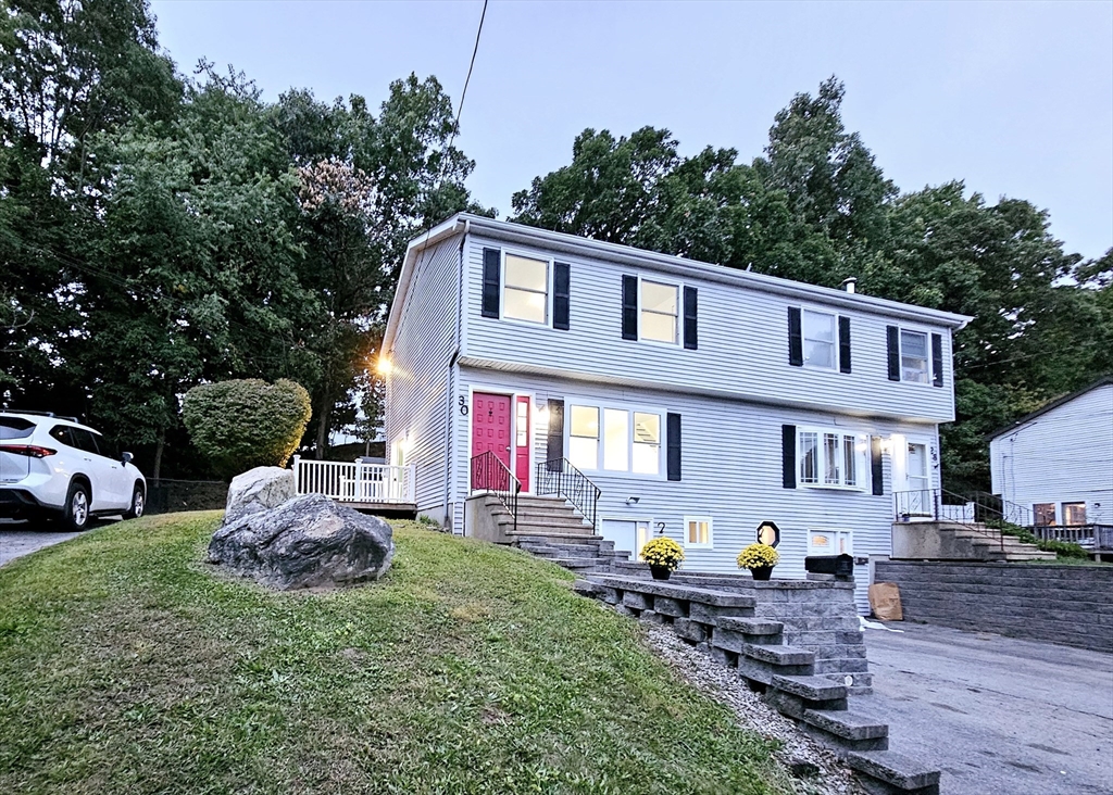 a front view of house with yard and outdoor seating