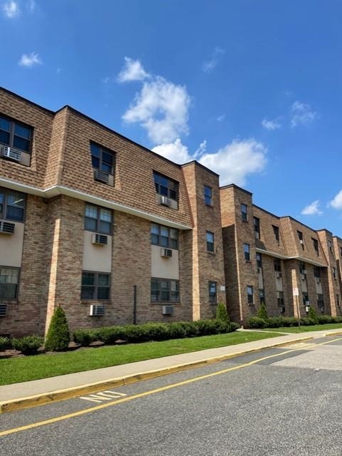 a view of a brick building next to a yard