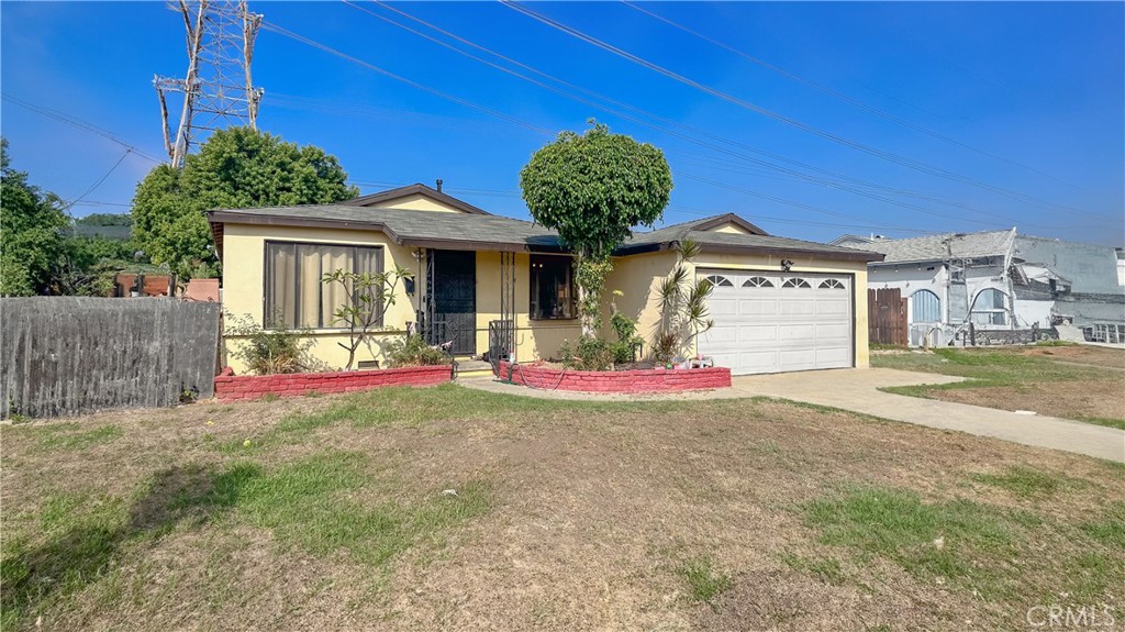 a view of a house with a yard and a garage