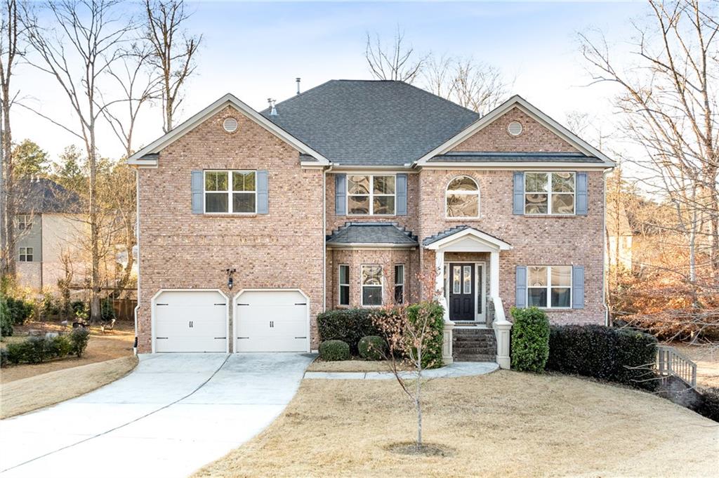 a front view of a house with a yard and garage