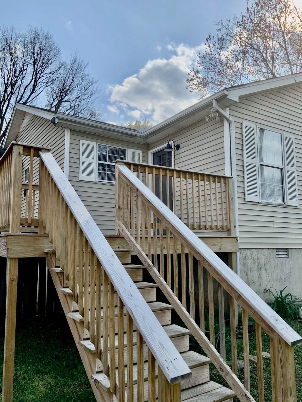 a balcony with wooden floor and stairs