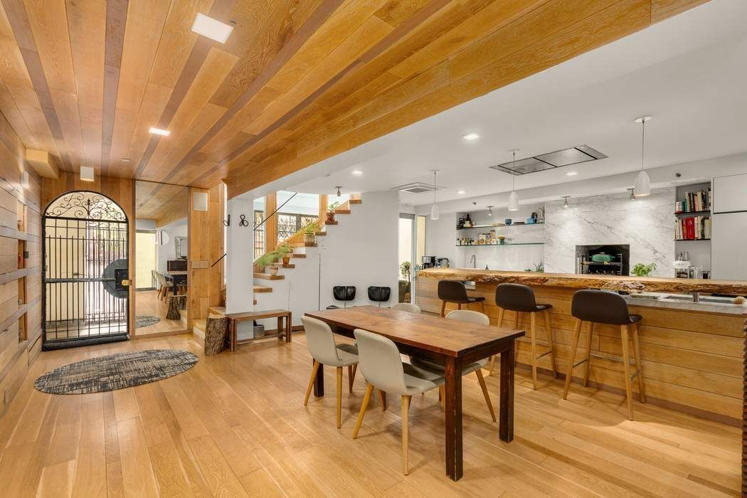 a living room with lots of furniture and a wooden floor