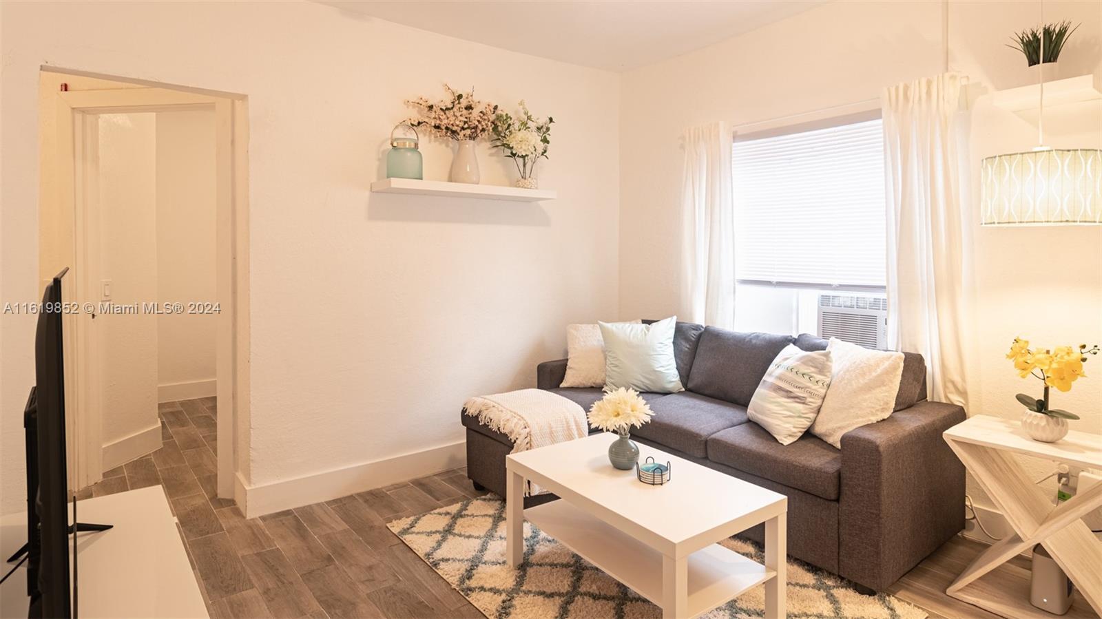 a living room with furniture and a window