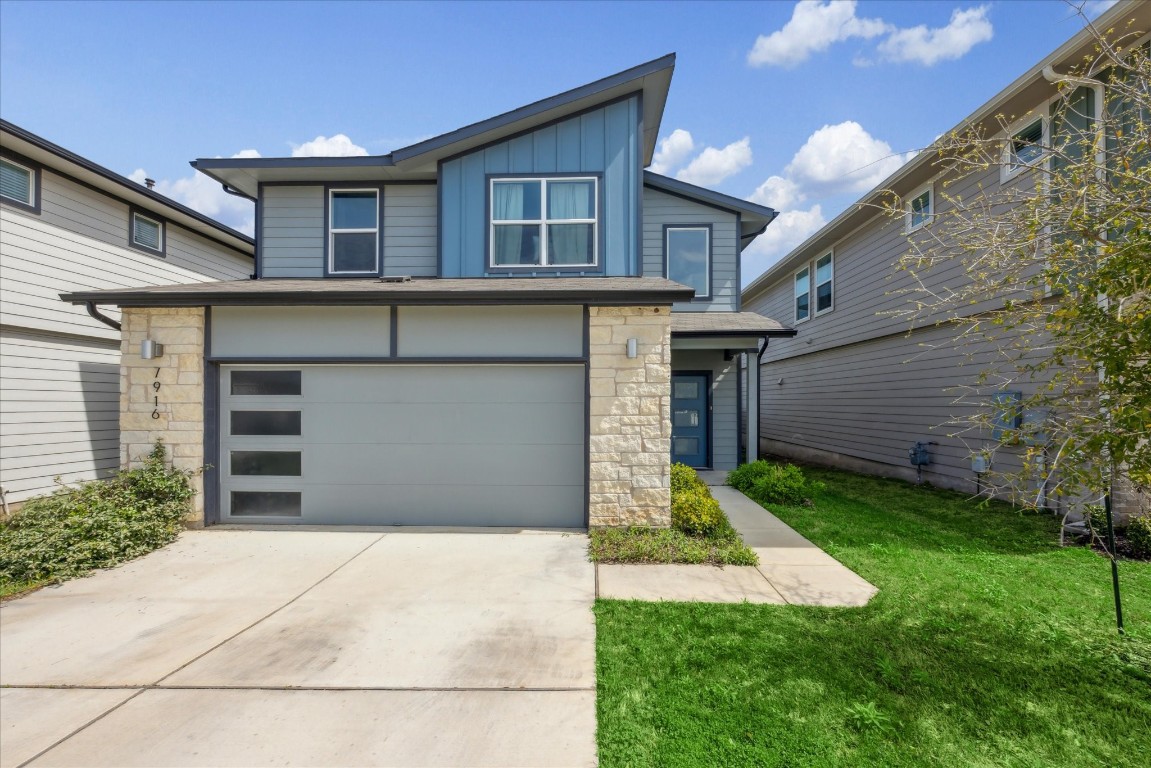 a front view of a house with a yard and garage