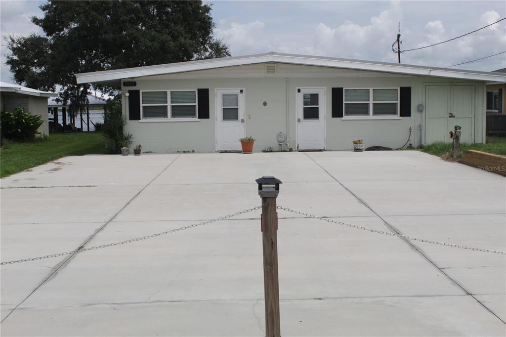 a front view of house with yard and trees around