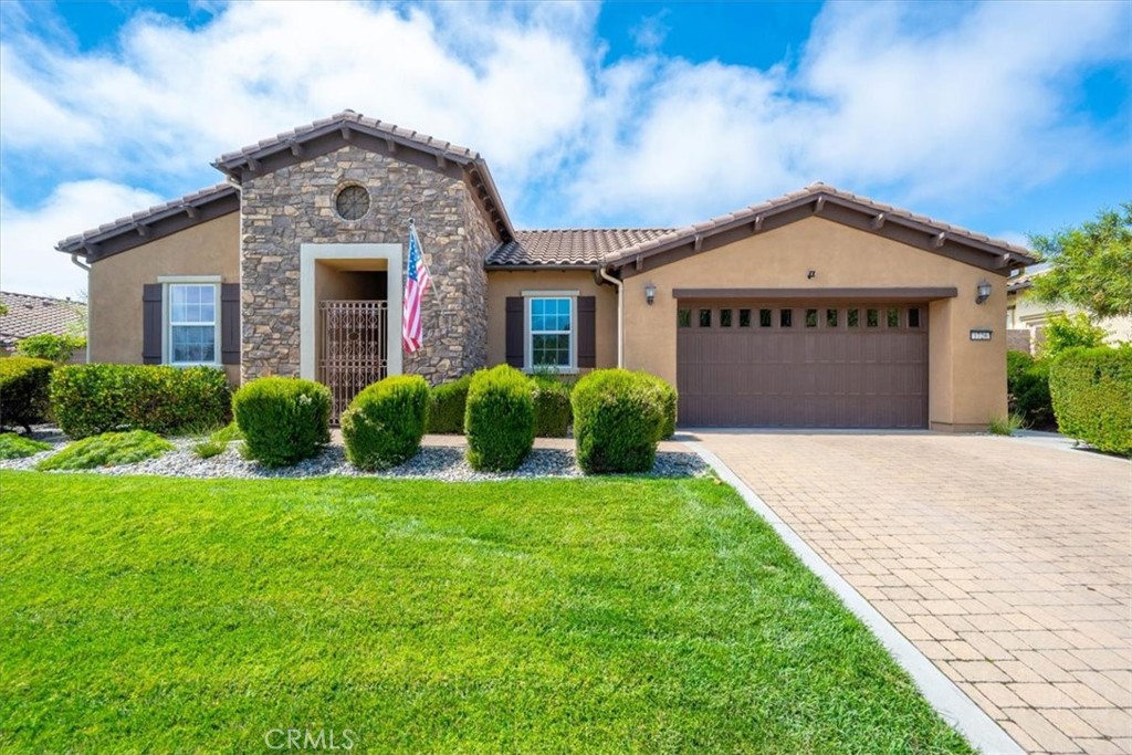 a front view of a house with a yard and garage