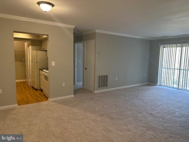 a view of a big room with windows and chandelier