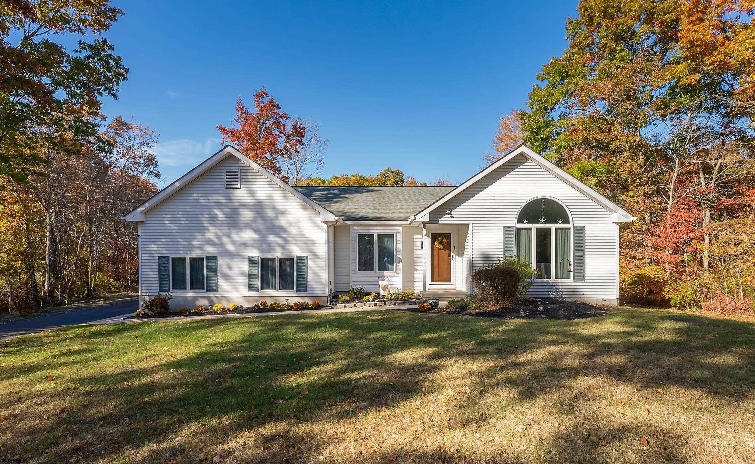 a front view of house with yard and green space