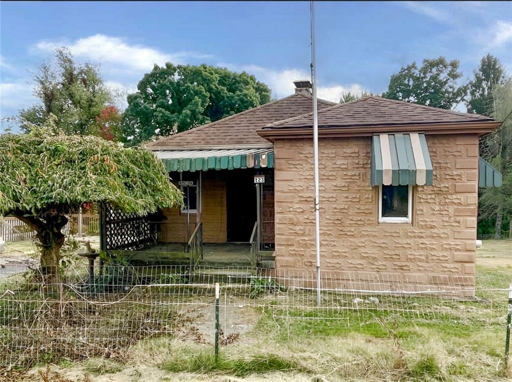 a front view of a house with plants