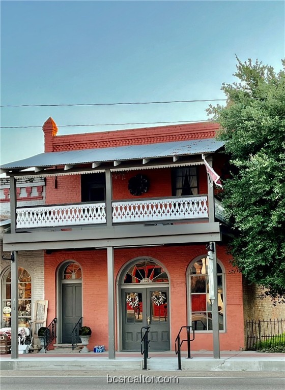 a view of building with glass windows and entrance